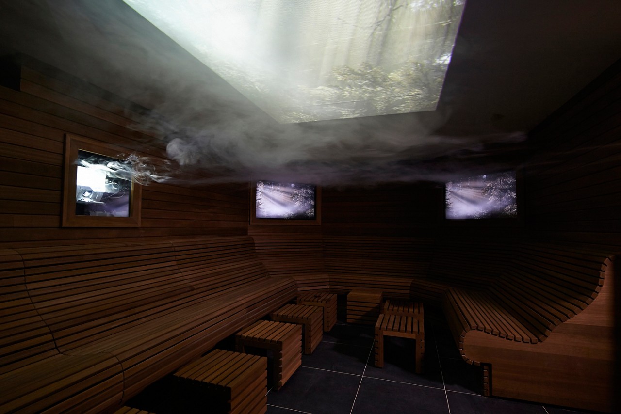 Steam filled sensory room with floral videos projected on the ceiling.